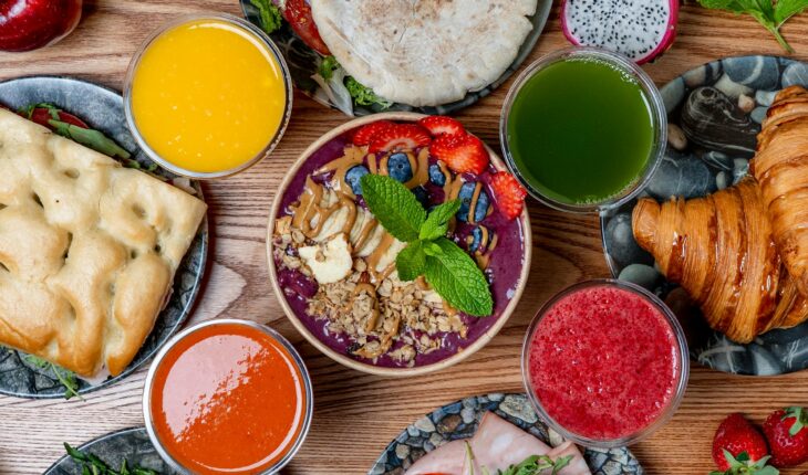 Vibrant breakfast spread featuring smoothies, pastries, and fresh fruits. Perfect for a healthy start.