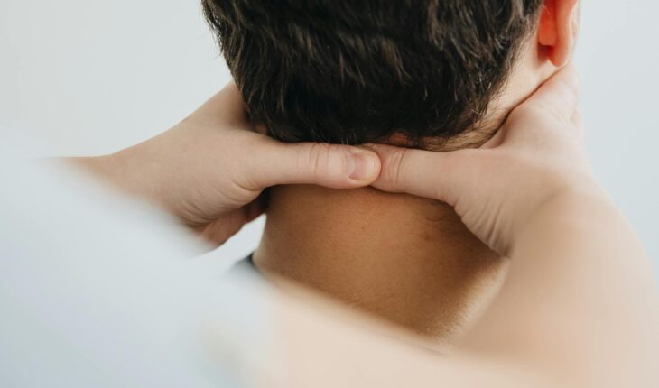 Close-up of a therapist massaging a patient's neck for pain relief and relaxation.