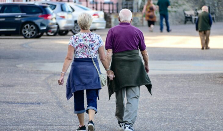 man and woman walking on the street during daytime